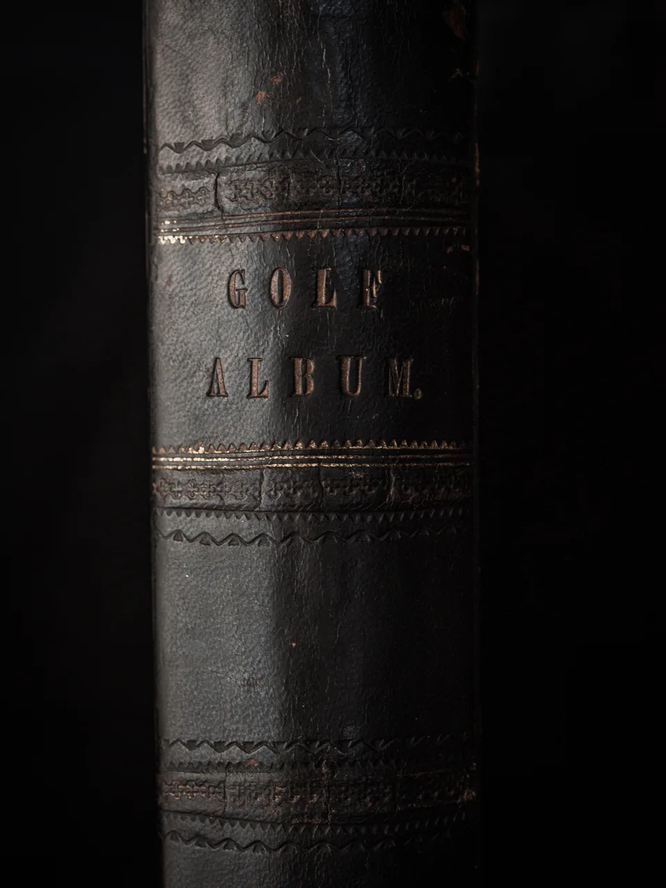 The tooled leather spine of a nineteenth-century volume titled Golf Album