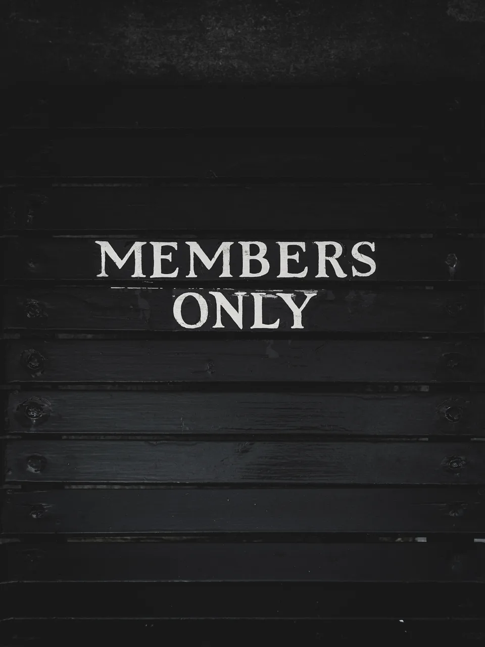 A dark painted panel lettered Members Only